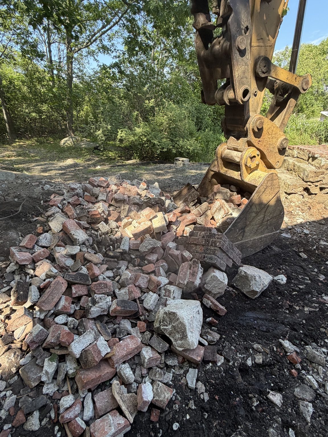 J’s Junk Services demolition equipment handling brick and concrete debris